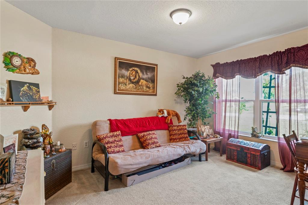9086 Manchester Street Spring Hill, FL 34606 - Photo 10 of 50 a living room with furniture a couch and a large window