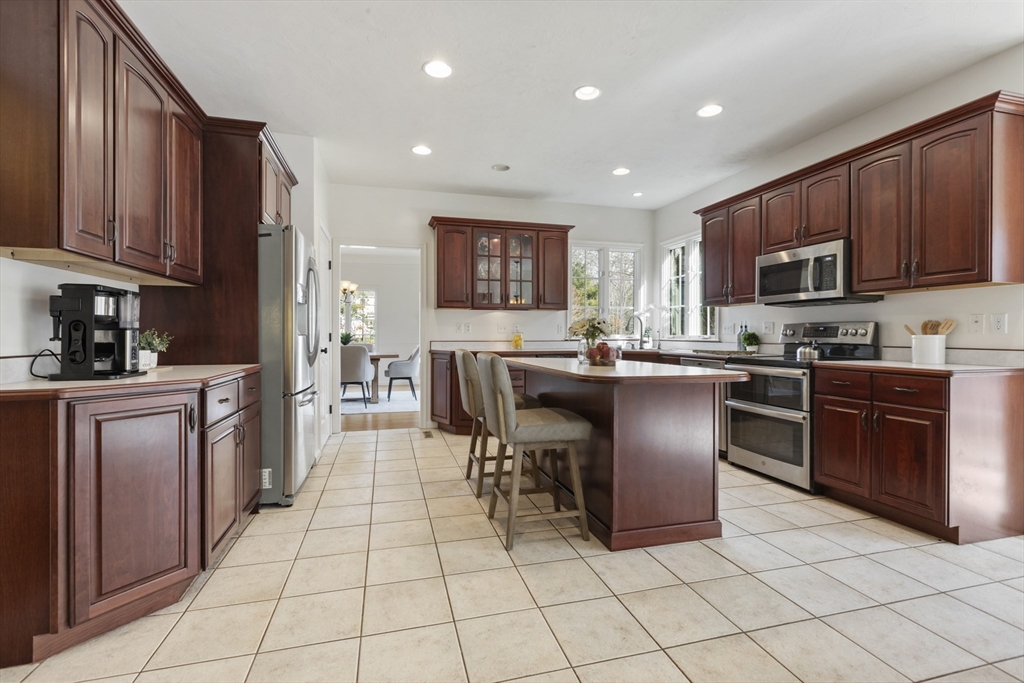 10 Anna Way Norton, MA 02766 - Photo 11 of 40 a kitchen with stainless steel appliances granite countertop a stove top oven a sink a counter top space and cabinets