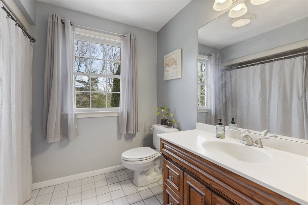 10 Anna Way Norton, MA 02766 - Photo 27 of 40 a bathroom with a sink a toilet and a large mirror