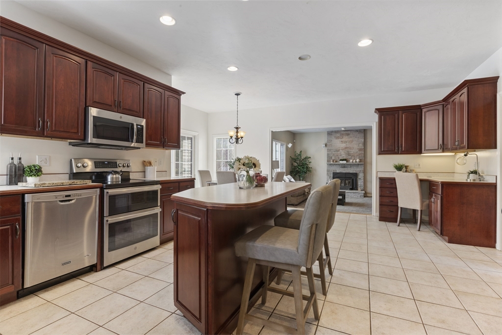 10 Anna Way Norton, MA 02766 - Photo 10 of 40 a kitchen with stainless steel appliances a stove a sink a microwave a refrigerator and cabinets