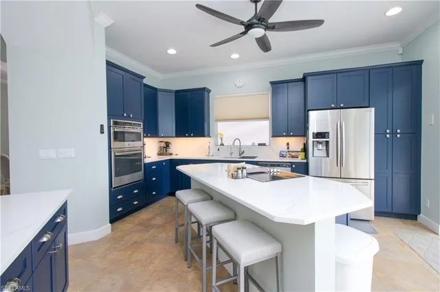 a kitchen with a refrigerator a stove a sink and a cabinets