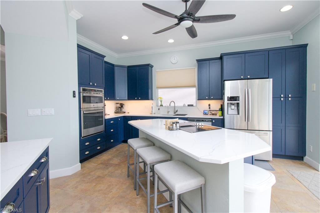 372 Mallory Court Naples, FL 34110 - Photo 11 of 48 a kitchen with a refrigerator a stove a sink and a cabinets