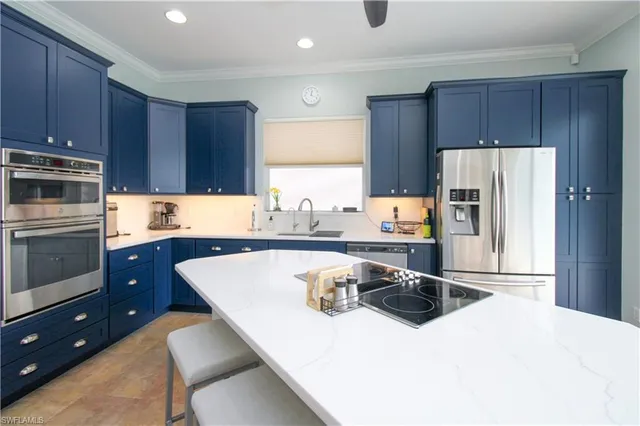 a kitchen with stainless steel appliances a stove a sink a microwave and wooden cabinets