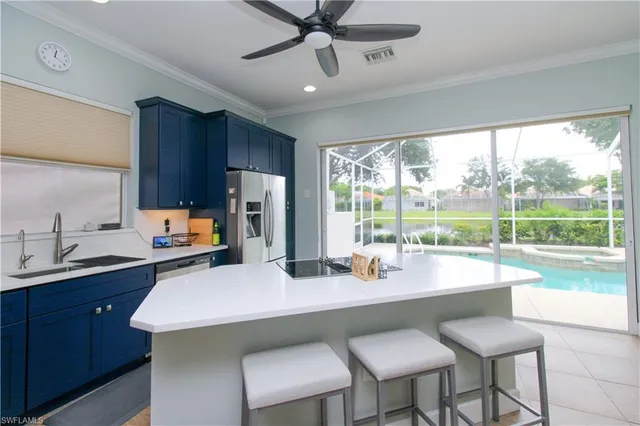 a kitchen with a table chairs sink and cabinets