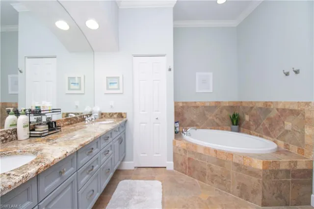a spacious bathroom with a granite countertop tub sink and mirror