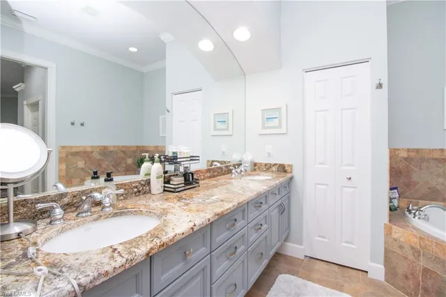 a bathroom with double vanity and a mirror