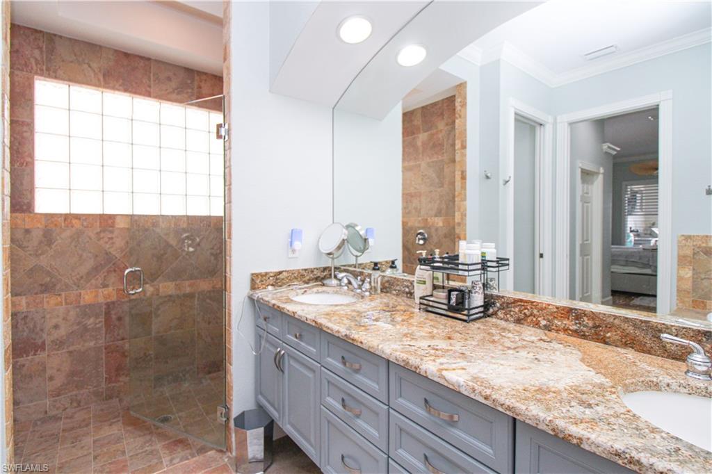 372 Mallory Court Naples, FL 34110 - Photo 19 of 48 a bathroom with a granite countertop sink and a mirror