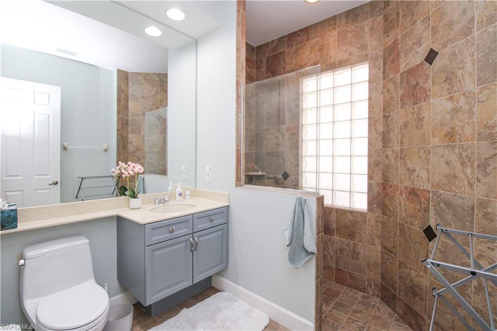 372 Mallory Court Naples, FL 34110 - Photo 23 of 48 a bathroom with a double vanity sink toilet and shower