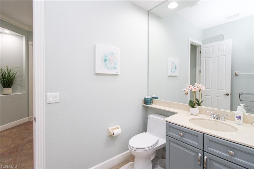 372 Mallory Court Naples, FL 34110 - Photo 24 of 48 a bathroom with a sink toilet and a mirror