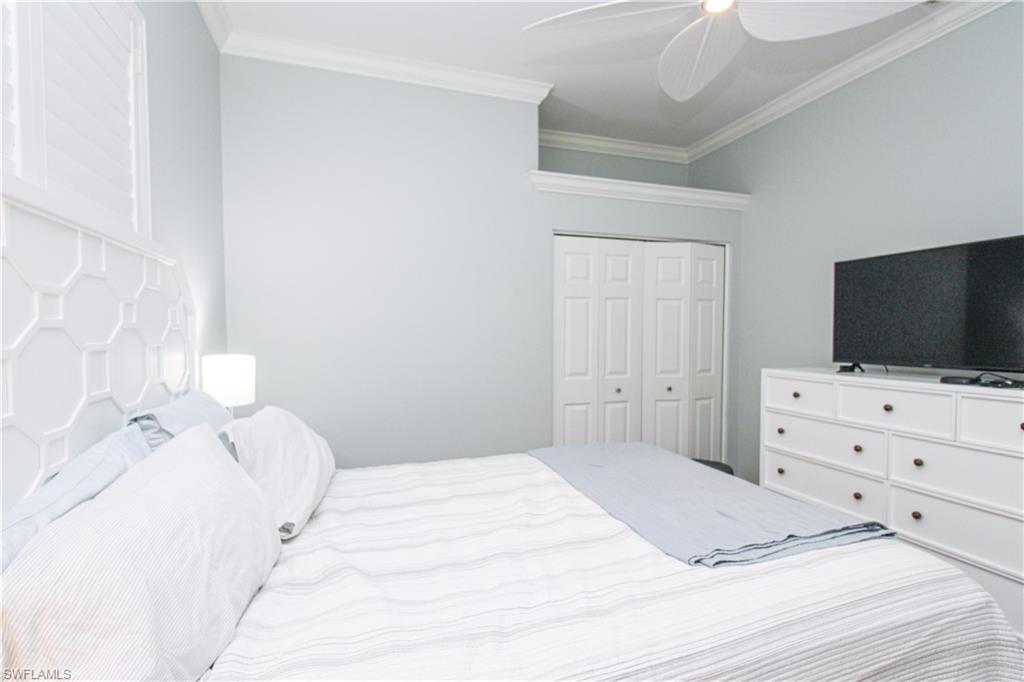 372 Mallory Court Naples, FL 34110 - Photo 26 of 48 a bedroom with a bed and a flat screen tv