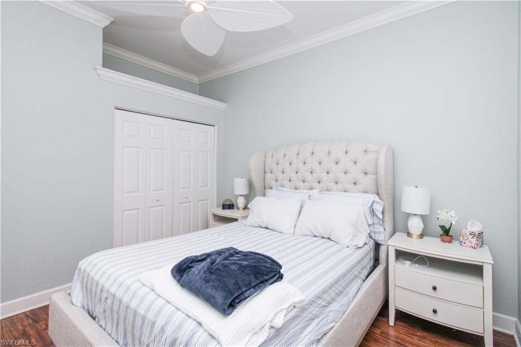 372 Mallory Court Naples, FL 34110 - Photo 29 of 48 a bedroom with a bed and a chandelier