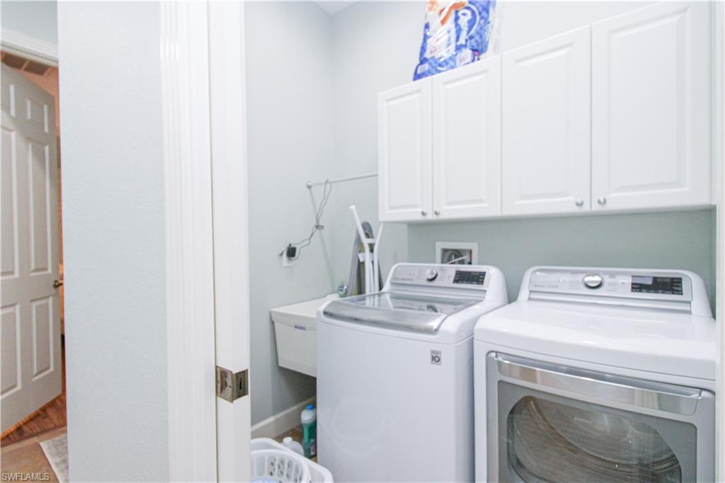 372 Mallory Court Naples, FL 34110 - Photo 33 of 48 a view of storage and utility room with washer and dryer
