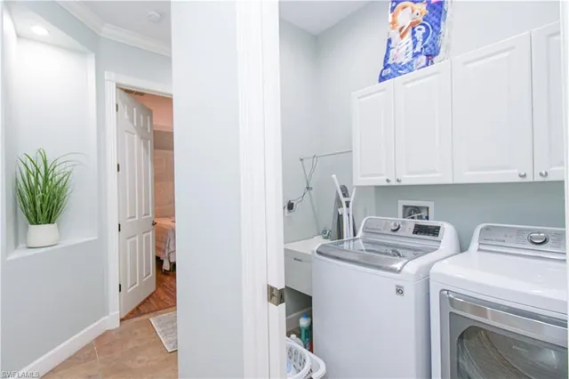 a view of storage and utility room with closet dryer and washer