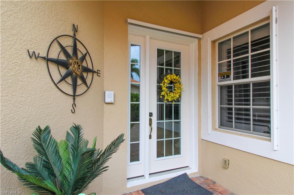 372 Mallory Court Naples, FL 34110 - Photo 36 of 48 a vase of flowers sitting on a floor