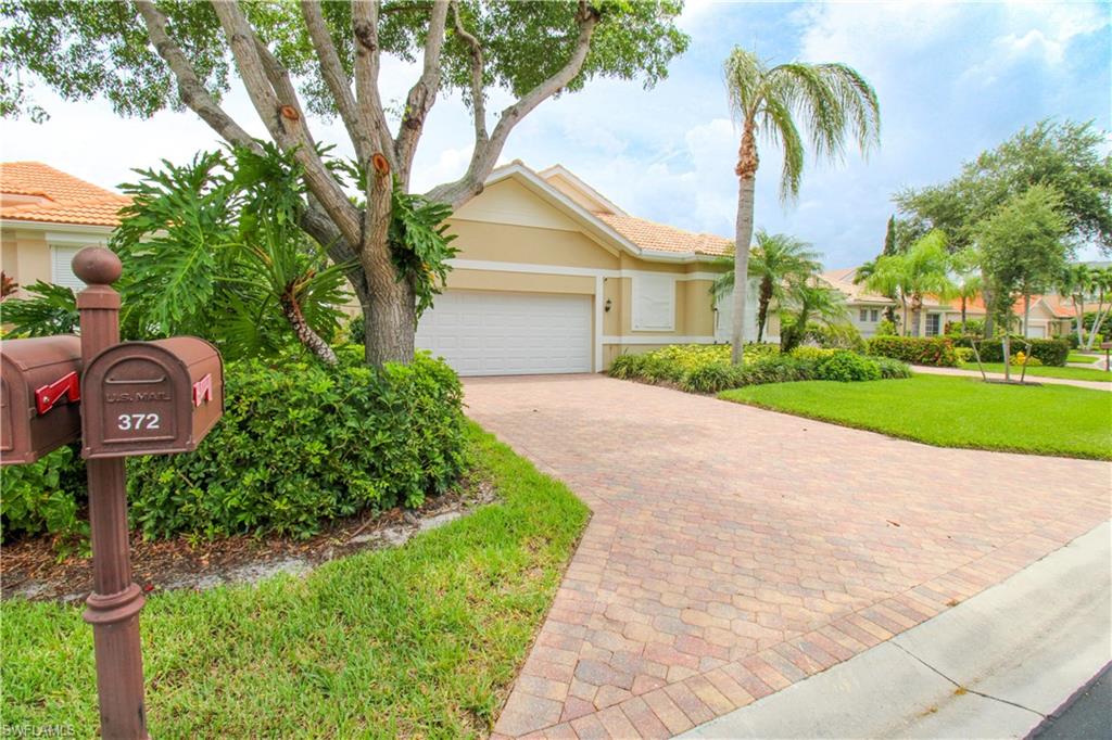 372 Mallory Court Naples, FL 34110 - Photo 38 of 48 a front view of a house with garden