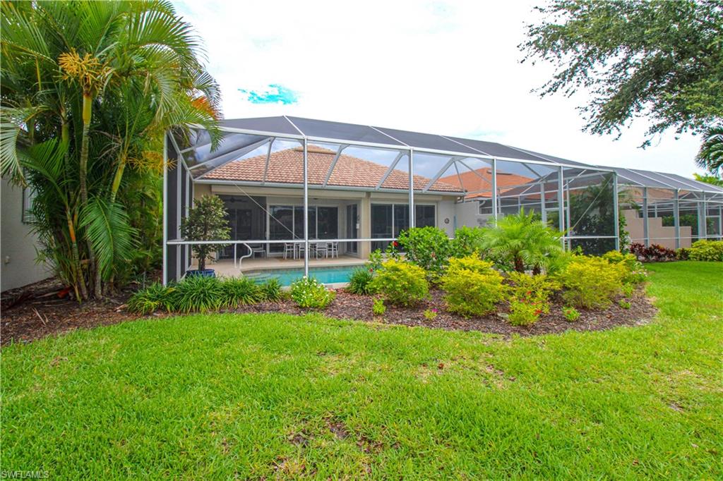 372 Mallory Court Naples, FL 34110 - Photo 41 of 48 a view of a house with a yard and sitting area