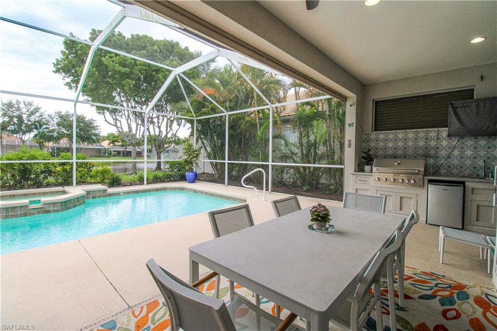 372 Mallory Court Naples, FL 34110 - Photo 42 of 48 a view of a patio with a table chairs and a table