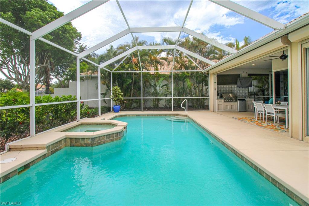 372 Mallory Court Naples, FL 34110 - Photo 44 of 48 a view of a swimming pool with a porch
