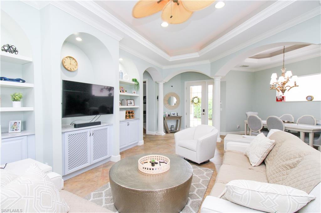 372 Mallory Court Naples, FL 34110 - Photo 6 of 48 a living room with furniture and a flat screen tv
