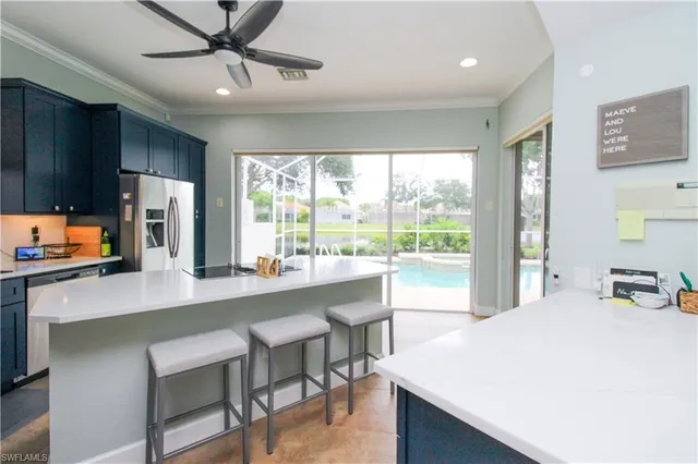 a large white kitchen with a large window