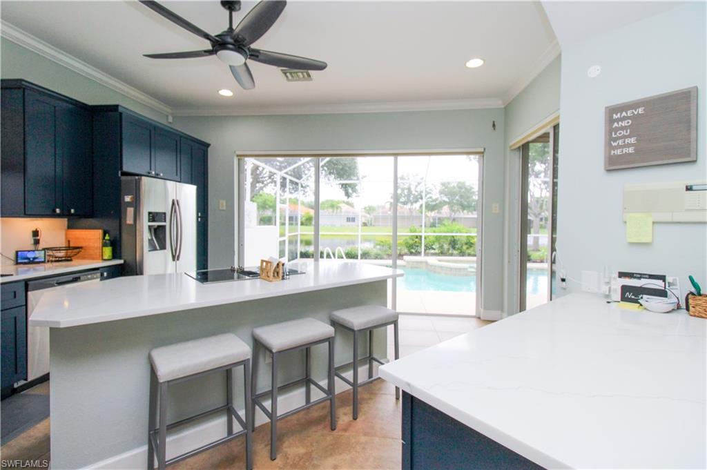 372 Mallory Court Naples, FL 34110 - Photo 7 of 48 a large white kitchen with a large window