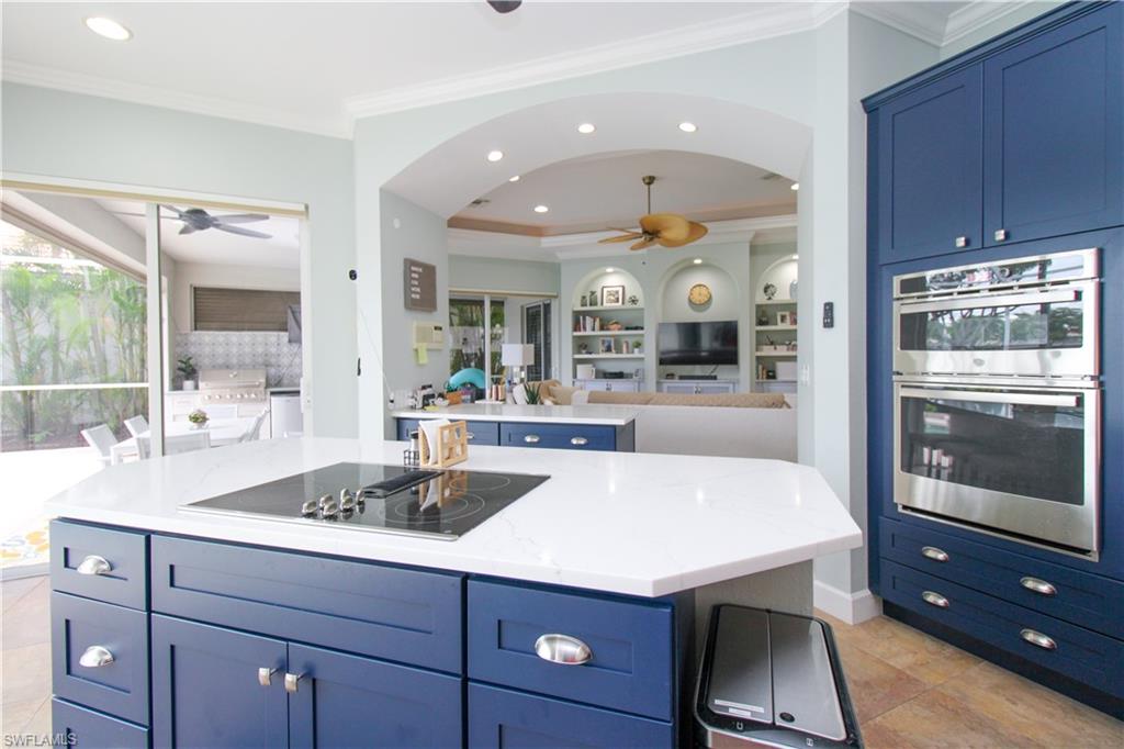 372 Mallory Court Naples, FL 34110 - Photo 9 of 48 a kitchen with a sink and wooden cabinets