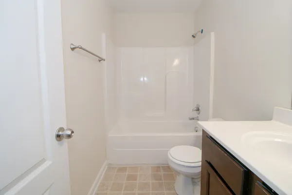 a bathroom with a sink toilet vanity and shower