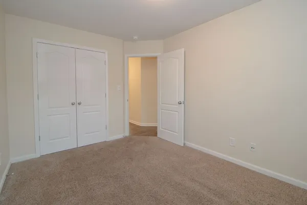 a view of an empty room and closet area
