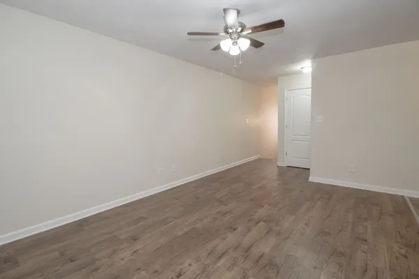 a view of an empty room with a fan
