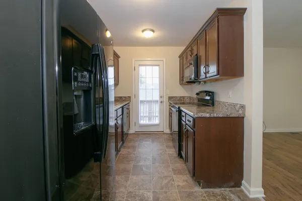 a kitchen with a refrigerator and a sink