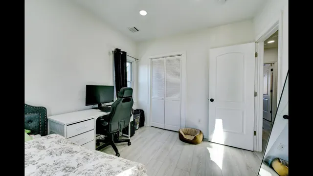 a bedroom with furniture and a wooden floor