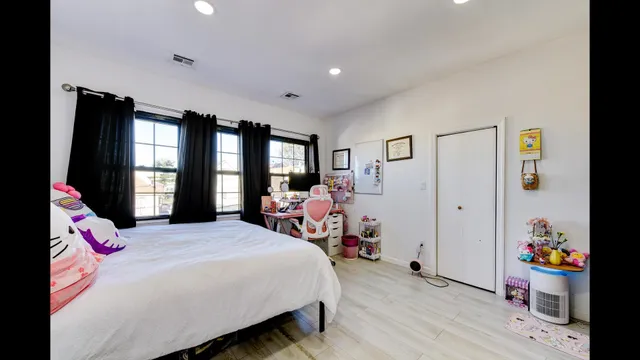 a bedroom with a bed and flat screen tv