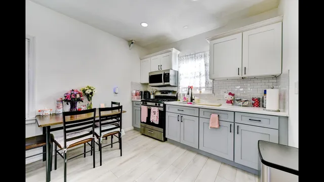 a kitchen with a refrigerator and a stove top oven