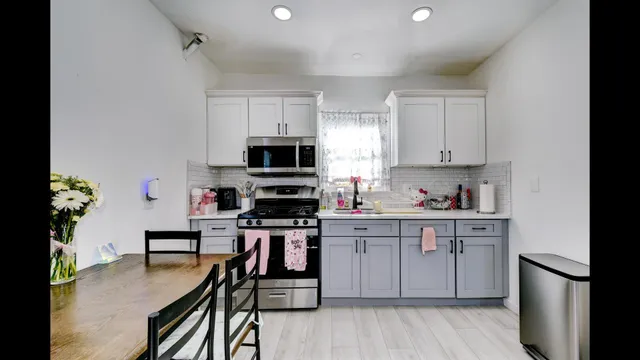 a kitchen with stainless steel appliances a stove a sink cabinets and a refrigerator