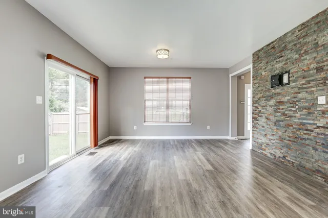 a kitchen with kitchen island granite countertop wooden floors appliances and furniture