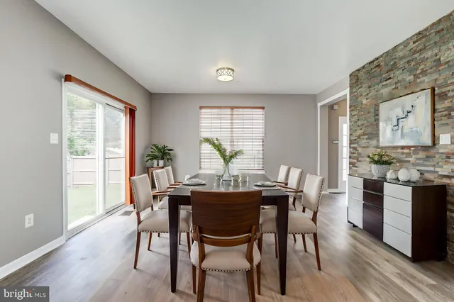 a kitchen with granite countertop white cabinets stainless steel appliances and a sink