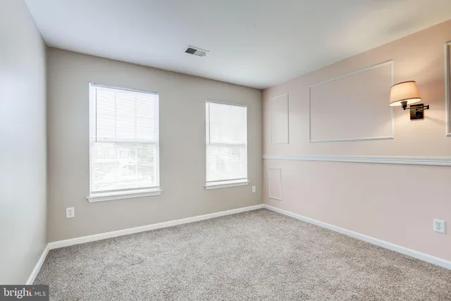 a front view of a house with a yard and outdoor seating