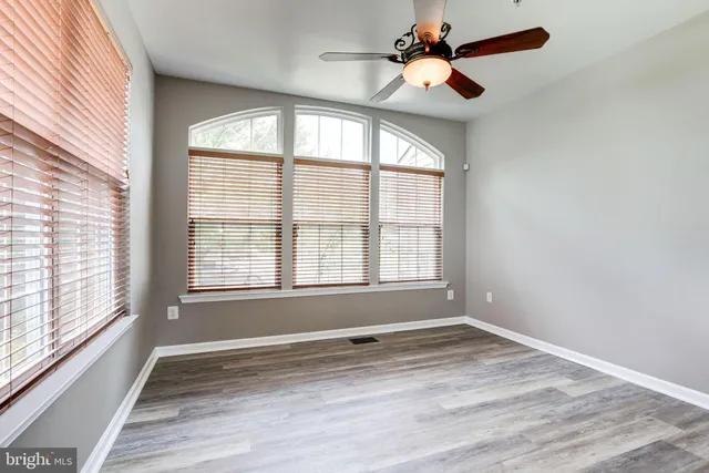 a living room with furniture a flat screen tv and a large window