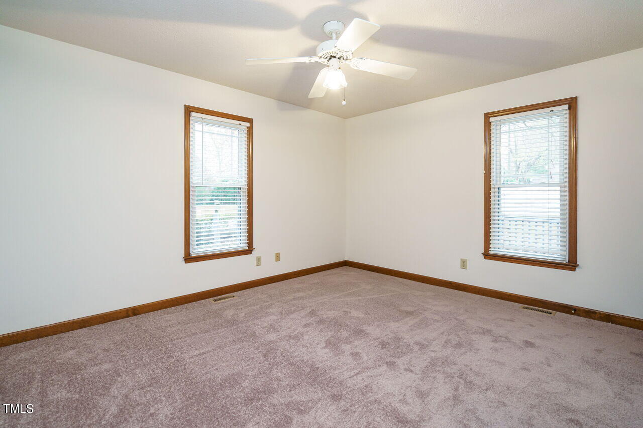 5917 Countryview Lane Raleigh, NC 27606 - Photo 14 of 43 Welcome to the spacious and inviting master suite, a sanctuary within your own home. As you enter, you'll immediately notice the fresh new carpet and paint that enhance the room's ambiance. These updates not only add a sense of modern comfort but also create a calming atmosphere, setting the stage for relaxation.