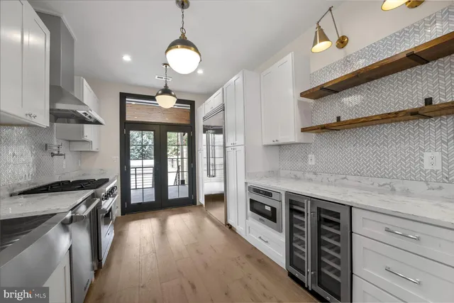 a kitchen with stainless steel appliances granite countertop a stove a sink and a refrigerator