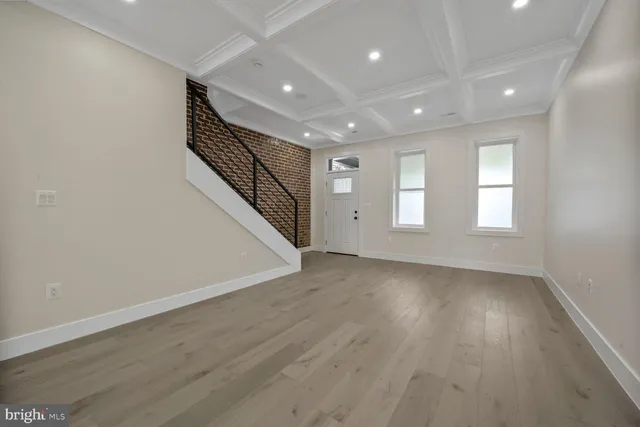 an empty room with a wooden floor and a window
