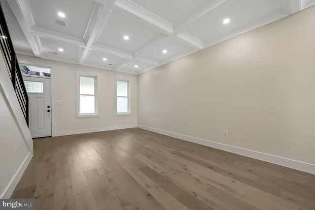 a view of a room with wooden floor and windows