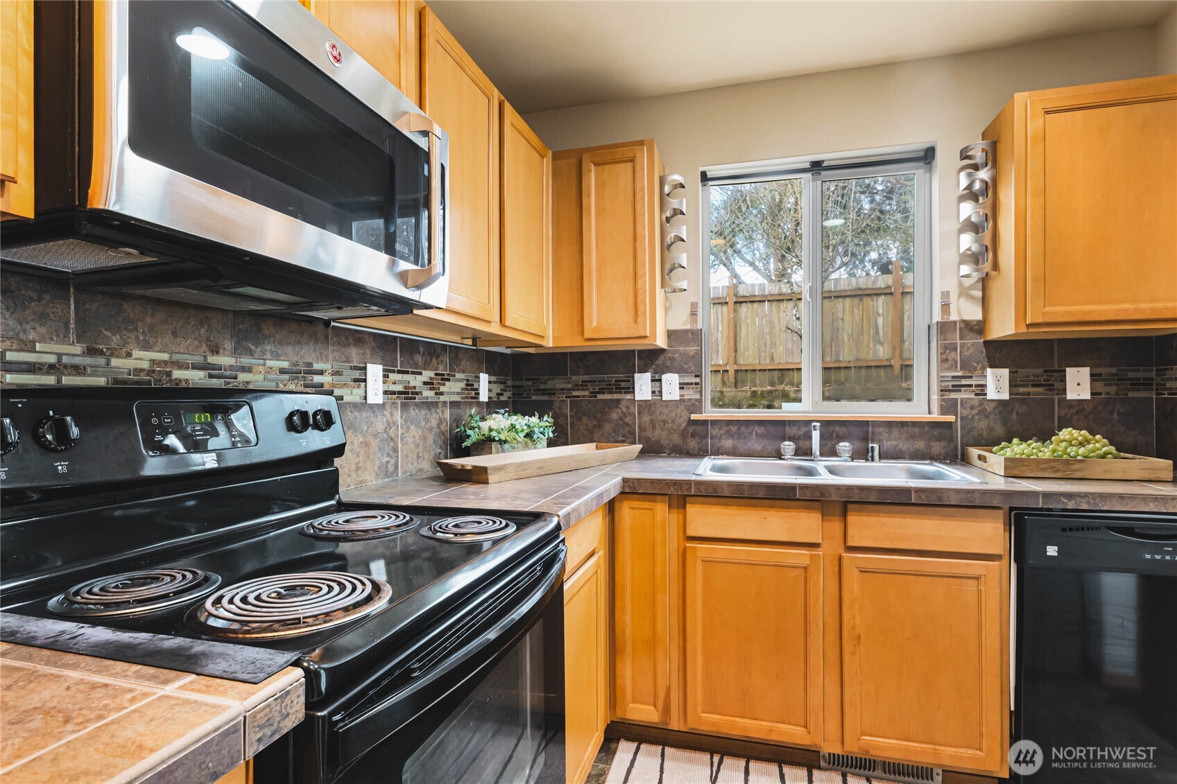 3765 Earendel Avenue Bremerton, WA 98310 - Photo 11 of 29 a kitchen with a stove a sink and a microwave