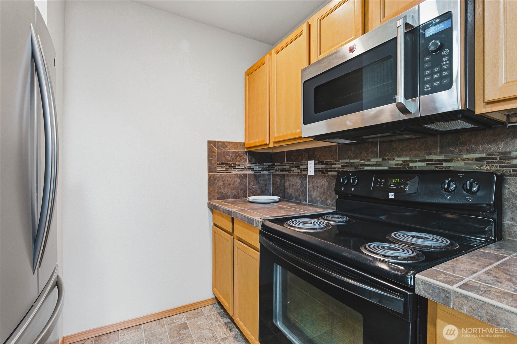 3765 Earendel Avenue Bremerton, WA 98310 - Photo 12 of 29 a kitchen with a stove and a microwave