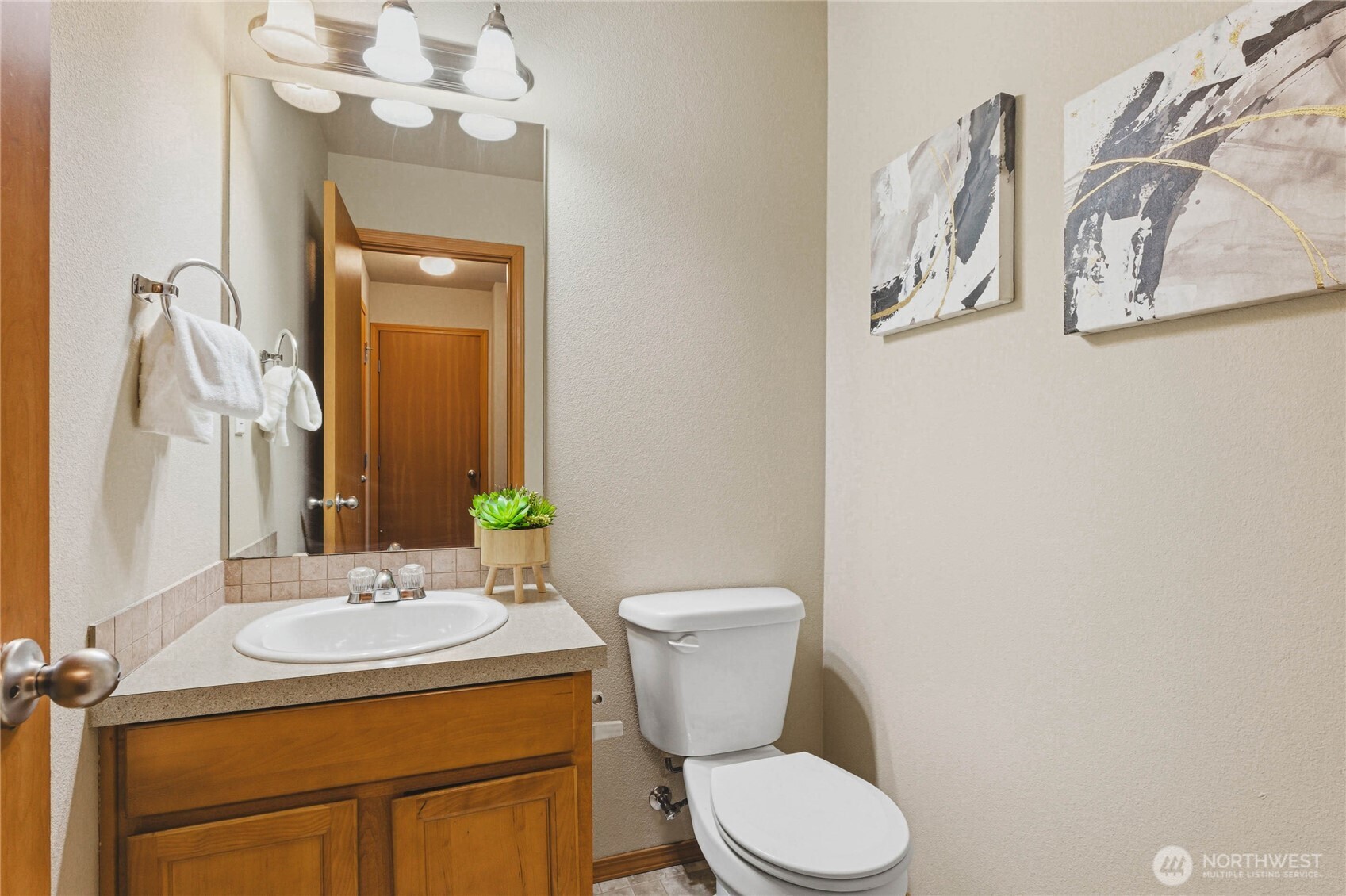 3765 Earendel Avenue Bremerton, WA 98310 - Photo 13 of 29 a bathroom with a granite countertop toilet sink and mirror