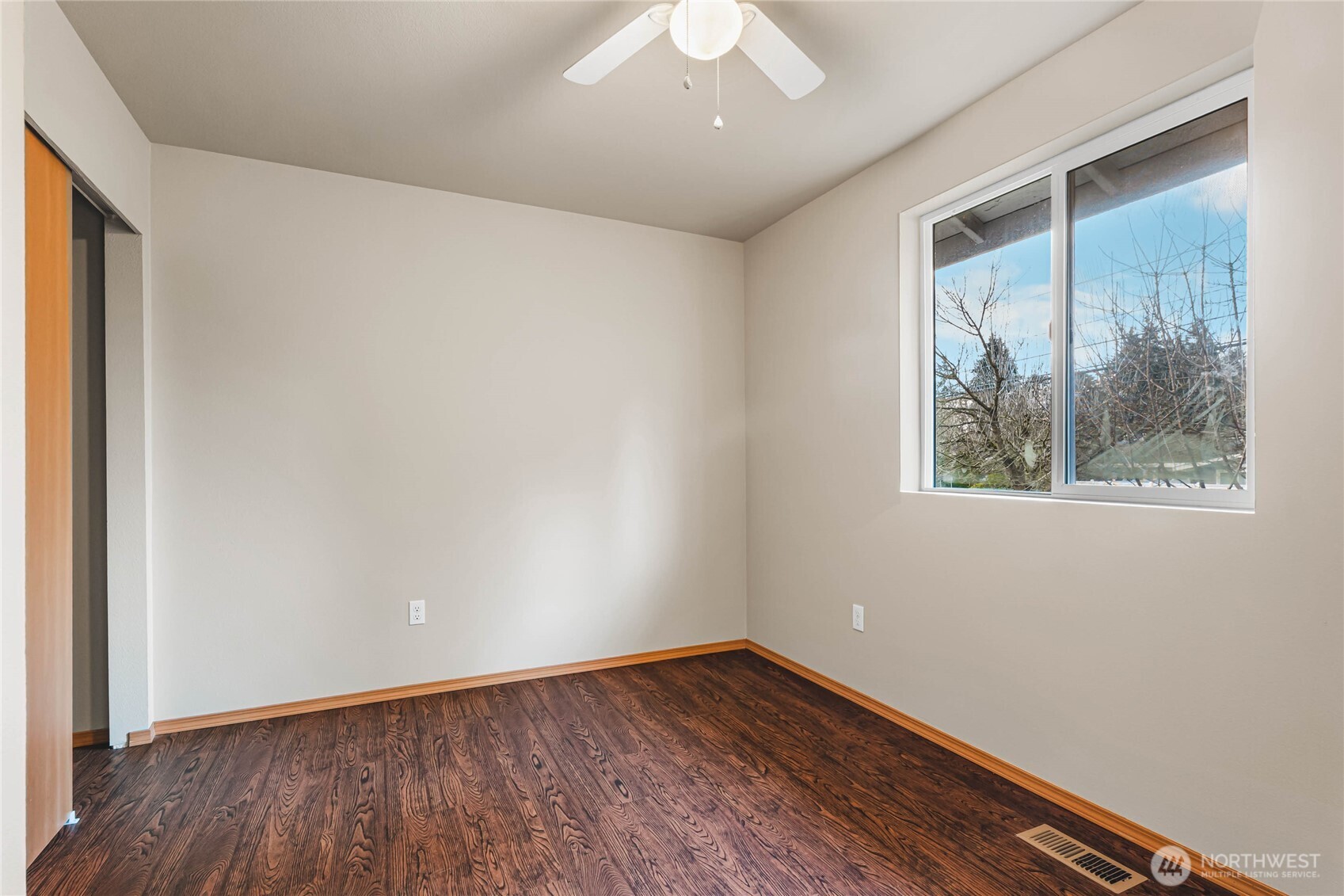 3765 Earendel Avenue Bremerton, WA 98310 - Photo 20 of 29 an empty room with wooden floor and windows