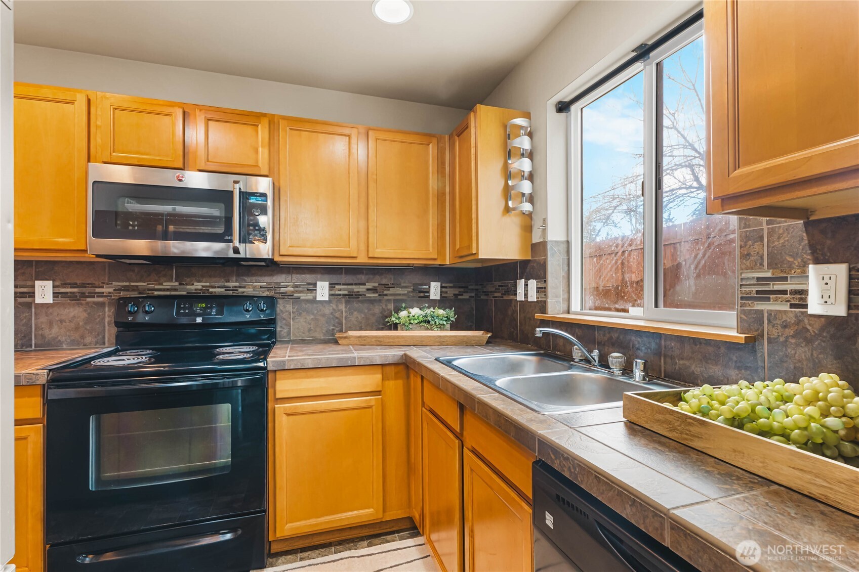 3765 Earendel Avenue Bremerton, WA 98310 - Photo 10 of 29 a kitchen with stainless steel appliances a stove sink and microwave