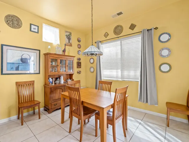 a view of a dining room with furniture and a window