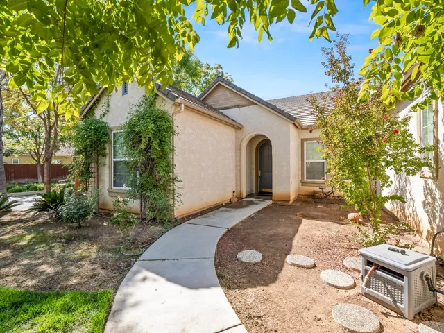 a view of a white house with a yard