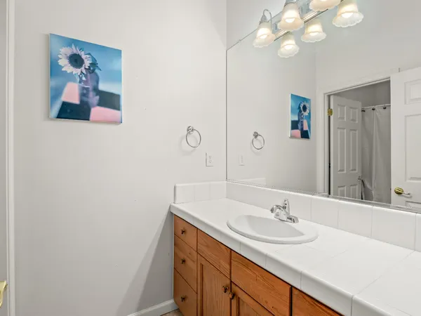 a bathroom with a sink a vanity and a mirror
